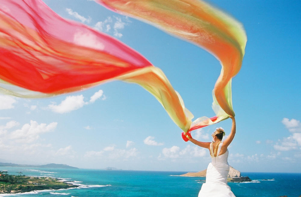 the bride jill holding her wedding arch material in the wind