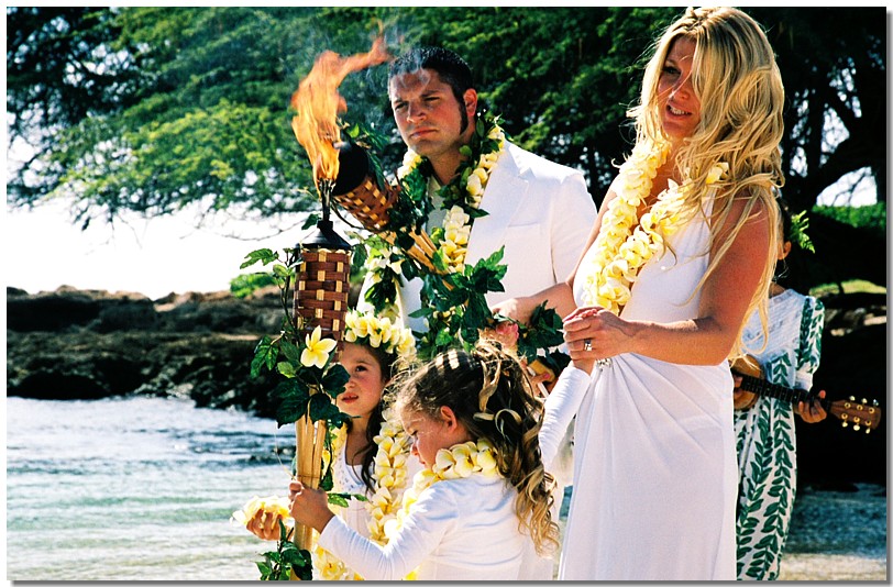 lighting the tiki torches at Paradise cove